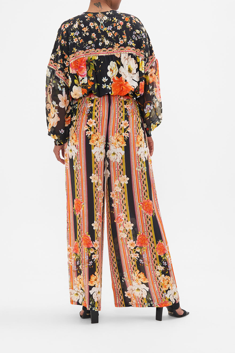 Back view of model wearing CAMILLA silk blouse in the Secret History print