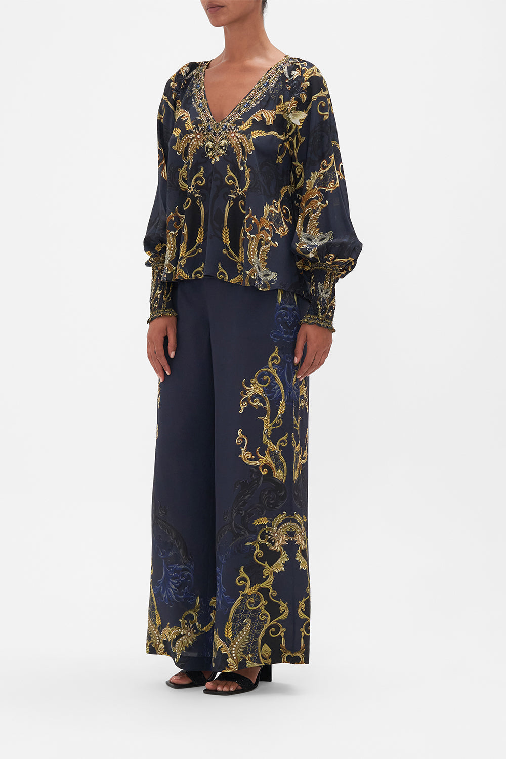 Side view of model wearing CAMILLA navy silk blouse in Moonlight Melodies print