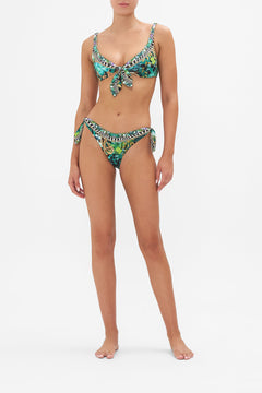 Front view of model wearing CAMILLA resort wear bikini bottom in Sing My Song print