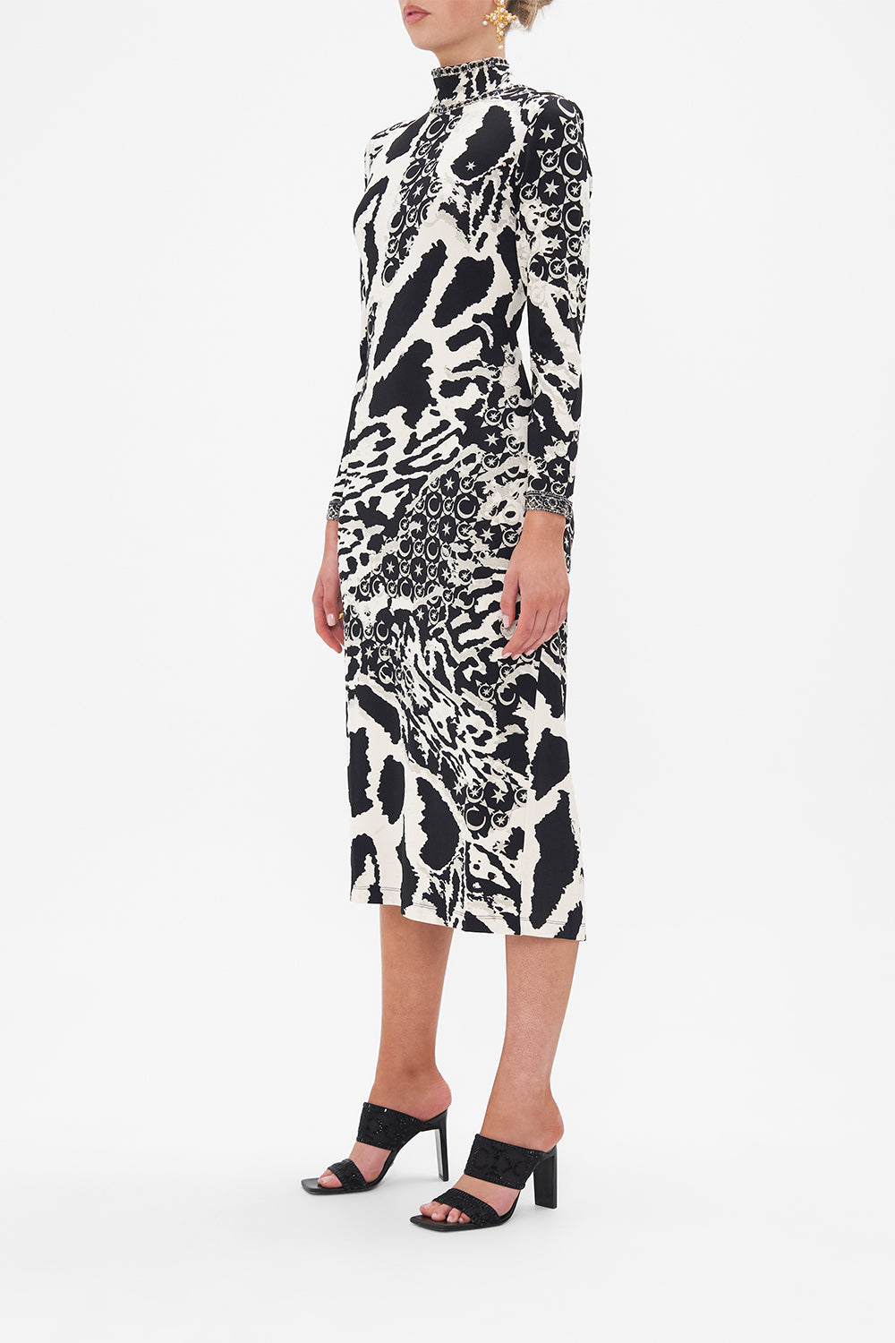 Side view of model wearing CAMILLA black and white jersey midi dress in Feline Fantasy print