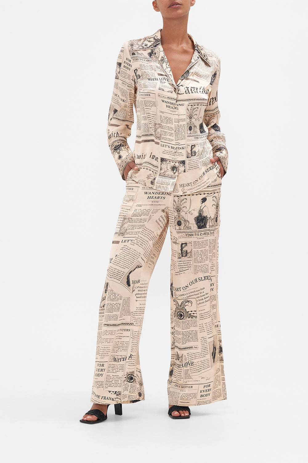 Front view of model wearing CAMILLA pink silk pyjama shirt in Fame Fever print 