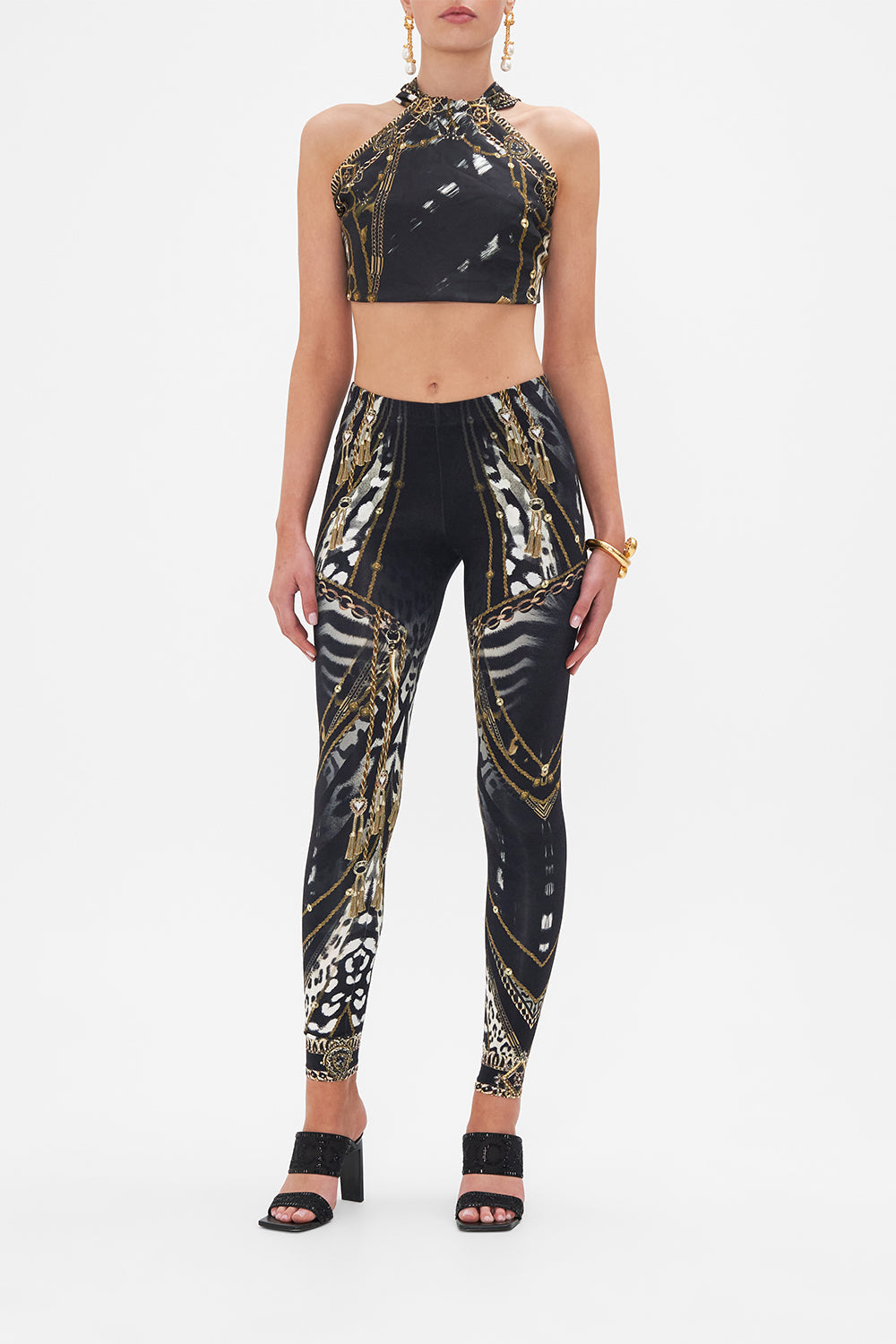 Front view of model wearing CAMILLA black and white animal print leggings in Untamed Royalty print