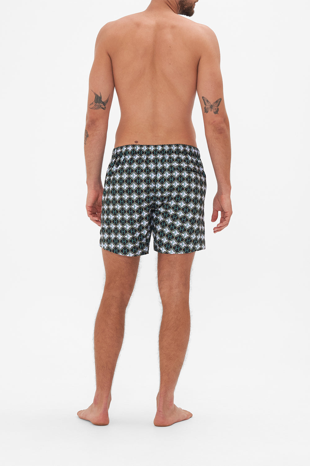 Back view of model wearing Hotel Franks by CAMILLA mens monogram print boardshorts in Jealousy And Jewels print