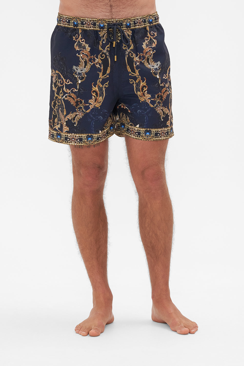 Crop view of model wearing Hotel Franks by CAMILLA mens navy boardshorts in Moonlight Melodies print