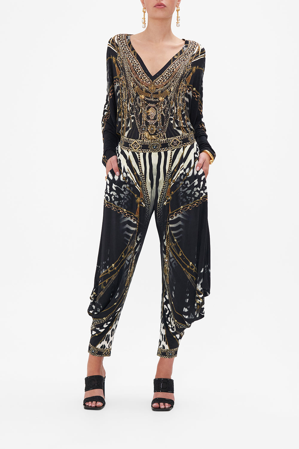 Front view of model wearing CAMILLA black and white animal print pants in Untamed Royalty print