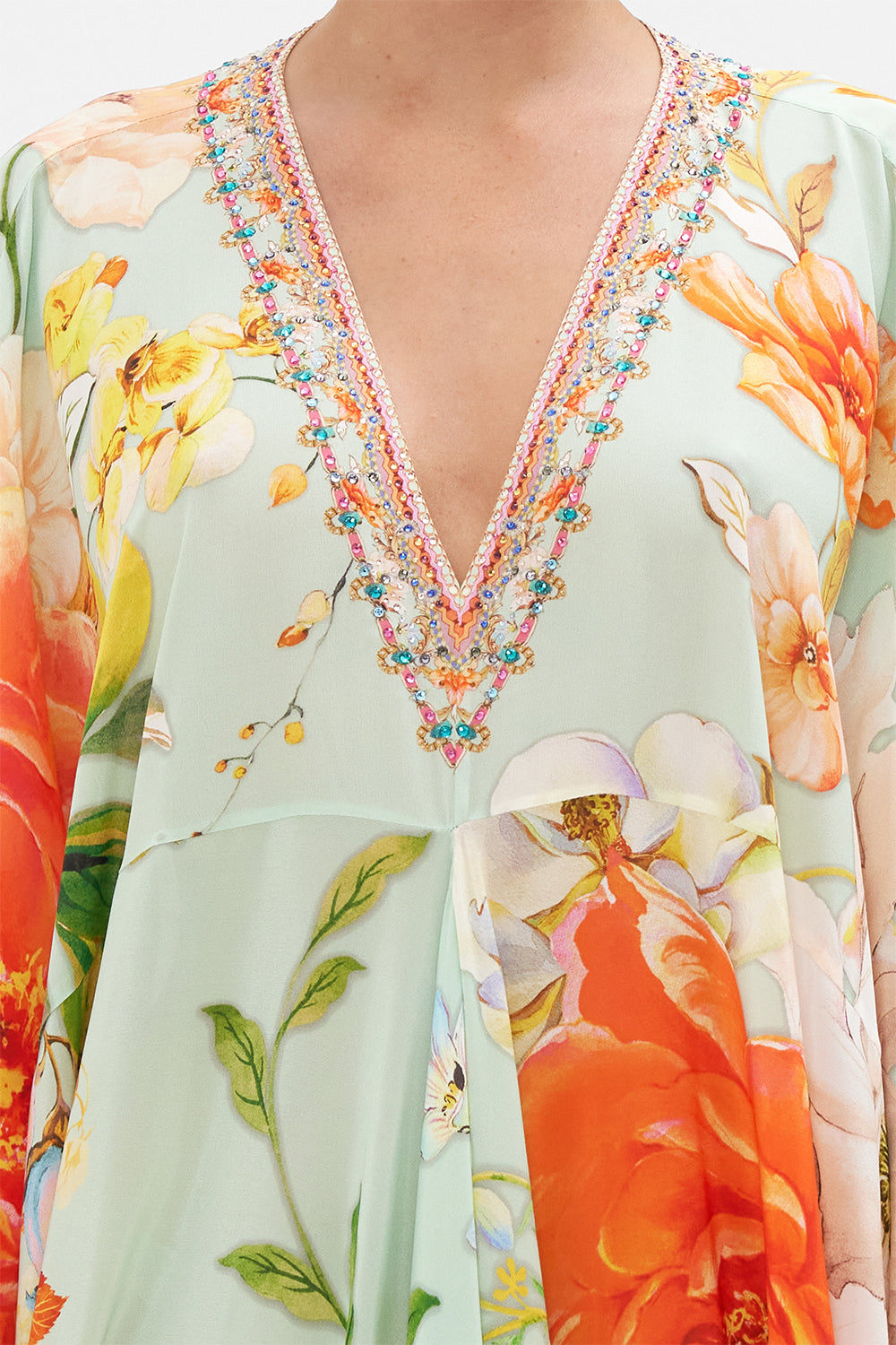 Detail view of model wearing CAMILLA floral silk kaftan in Talk The Walk print 