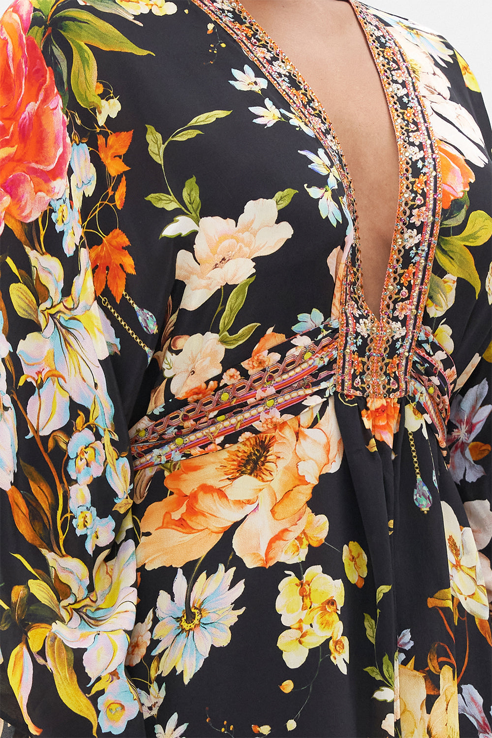 Detail view of model wearing CAMILLA floral silk kaftan in Secret History print