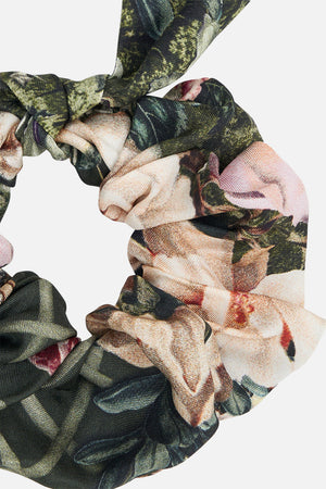 Detail view of CAMILLA silk scrunchie in floral Garden of Good Fortune  print