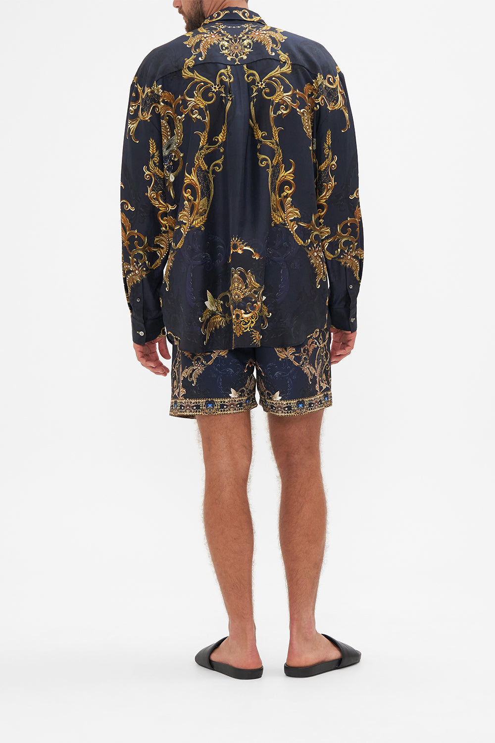 Back view of model wearing Hotel Franks By CAMILLA mens oversized shirt in Moonlight Melodies print