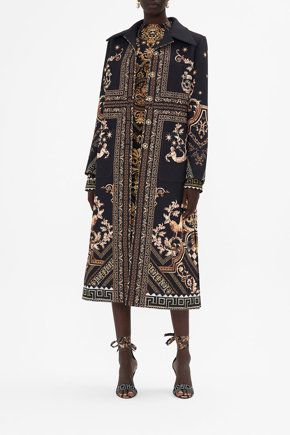 Front view of model wearing CAMILLA black and gold coat in Duomo Dynasty