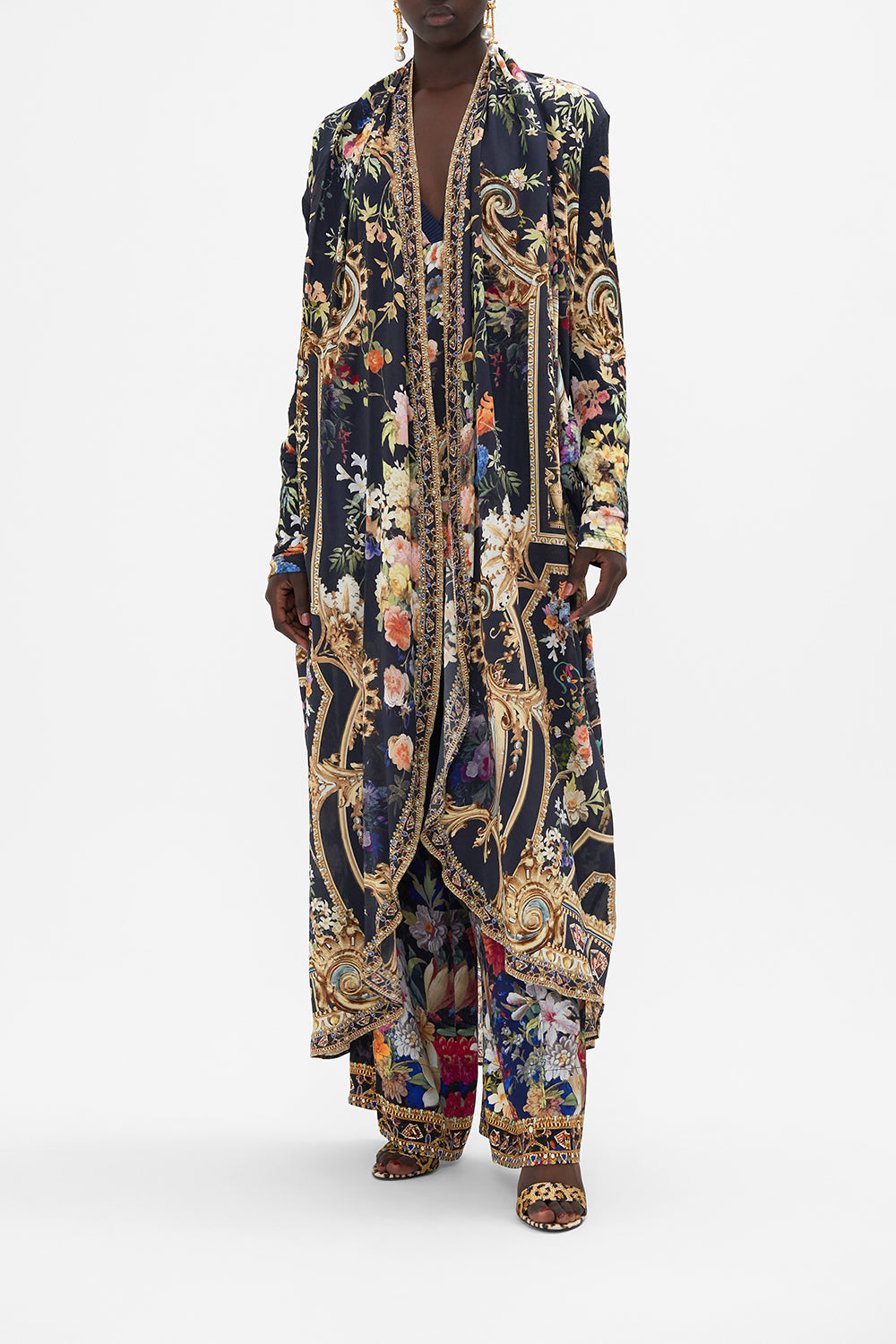 Front view of model wearing CAMILLA long  floral print jacket in Play Your Cards Right print