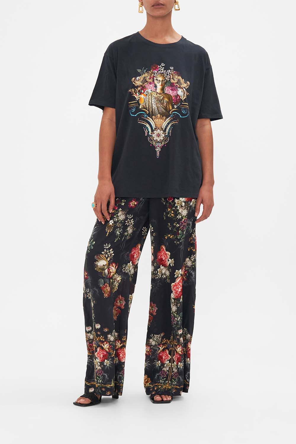 Front view of model wearing CAMILLA black oversize tee in A Night At The Opera print