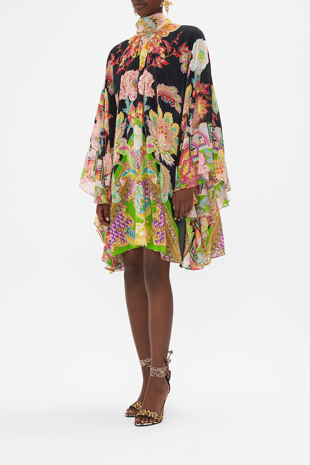 Side view of model wearing CAMILLA silk high neck ruffle dress in Sundowners in Sicily print 