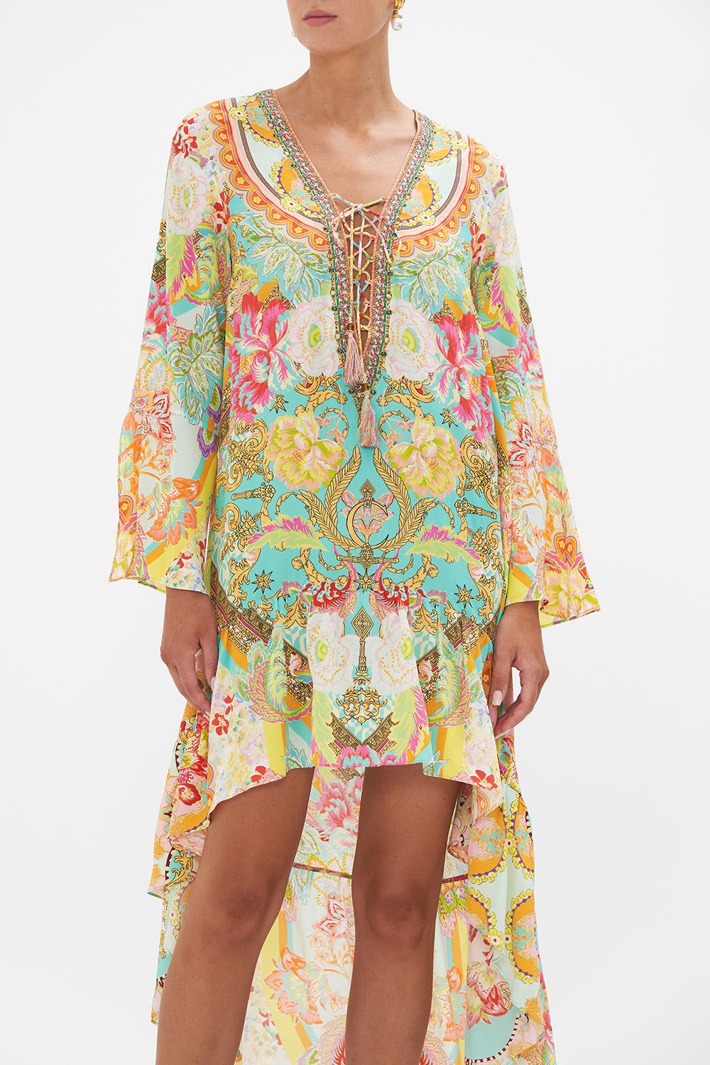 Crop view of model wearing CAMILLA silk mini dress with high low hem in An Italian Welcome print 