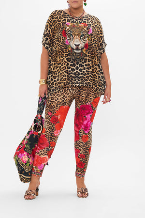 Front view of curvy model wearing CAMILLA plus size leggings in Heart Like A Wildflower print