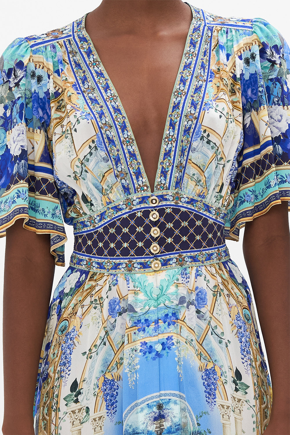 Detail view of model wearing CAMILLA silk dress with flutter sleeves in Views Of Vesuvius print
