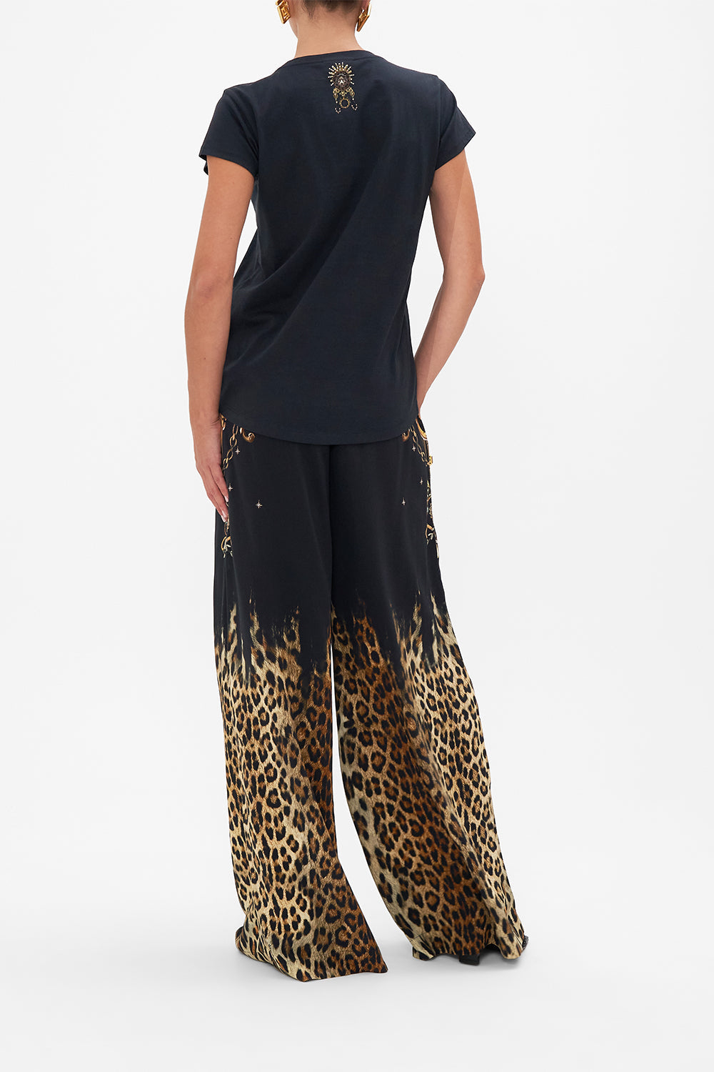 Back view of model wearing CAMILLA black graphic tee in Lions Mane print