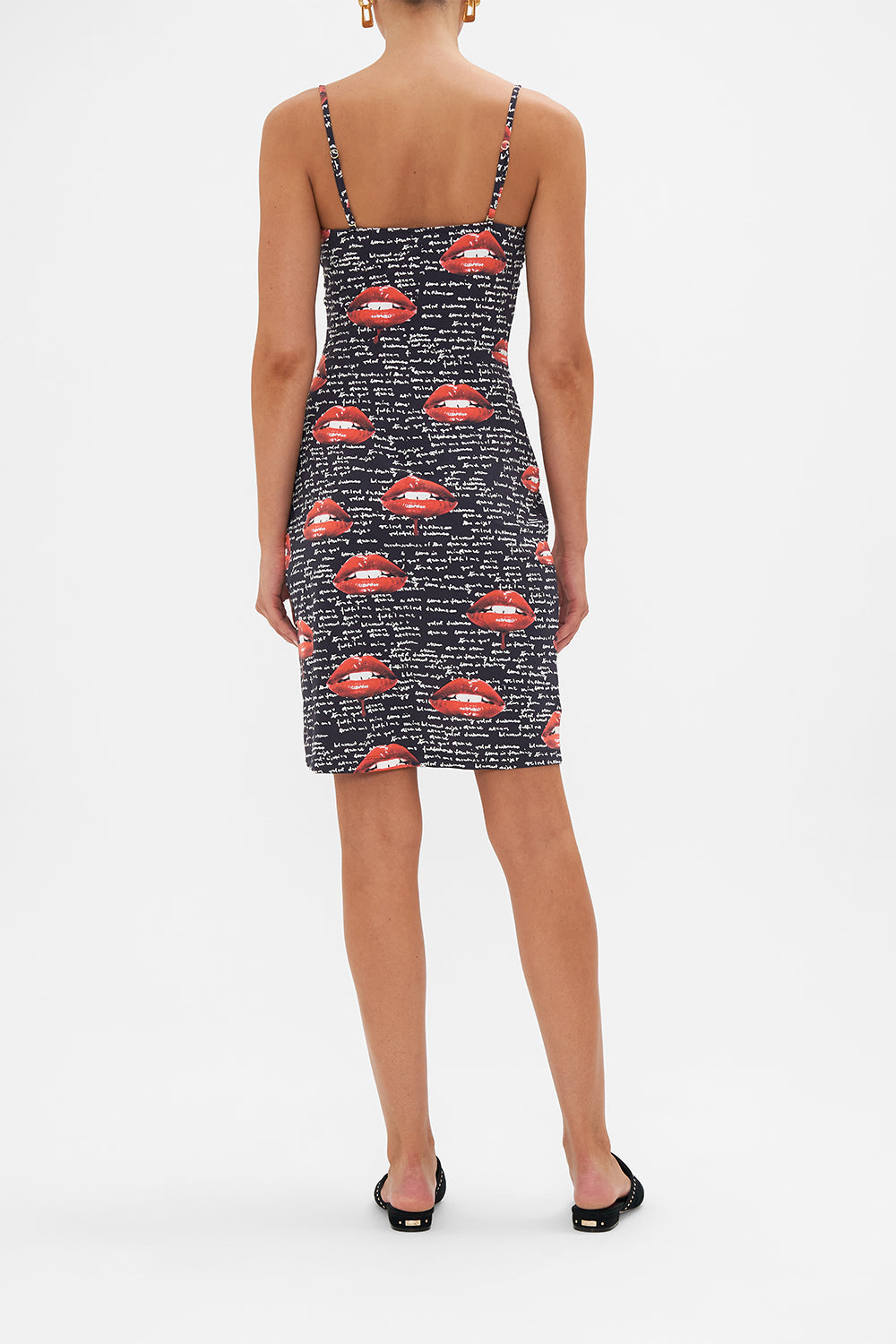 Back view of model wearing CAMILLA black slip dress in Chaos Magic print 