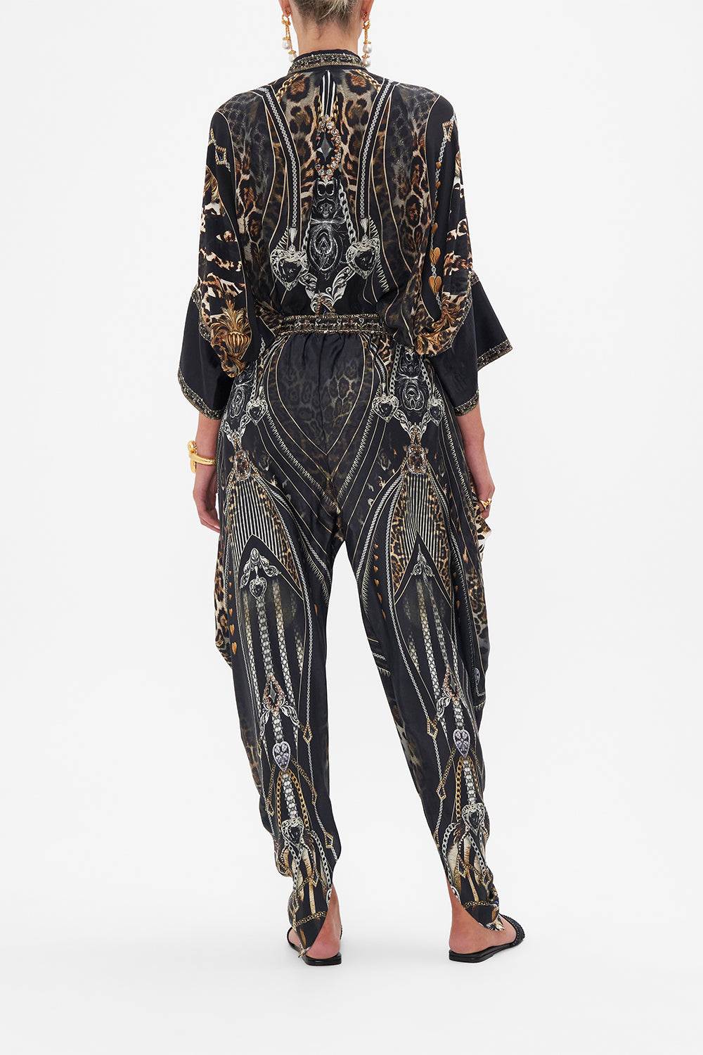 Back view of model wearing CAMILLA drapey silk pants  in Chaos In The Cosmos animal print