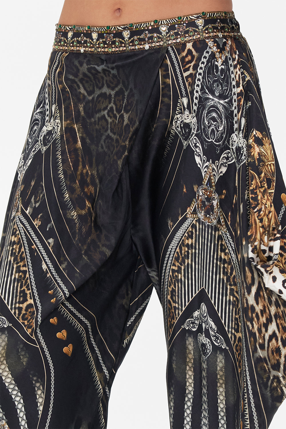 Detail view of model wearing CAMILLA drapey silk pants  in Chaos In The Cosmos animal print