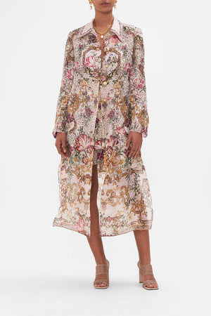 Front view of model wearing CAMILLA silk pink floral print coat in Bambino Bliss print