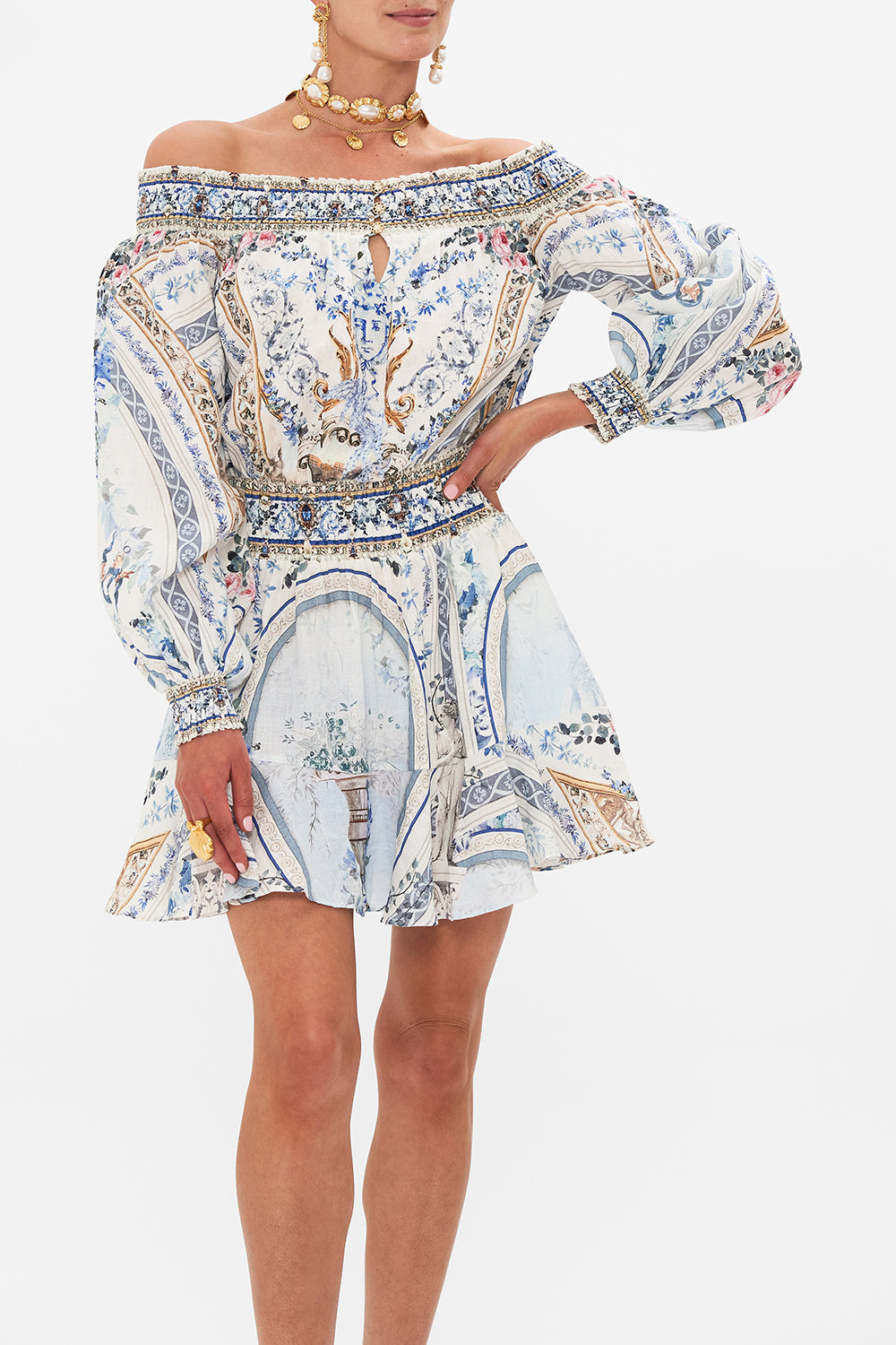 Crop view of model wearing CAMILLA designer off the shoulder mini dress in Season of the Siren print