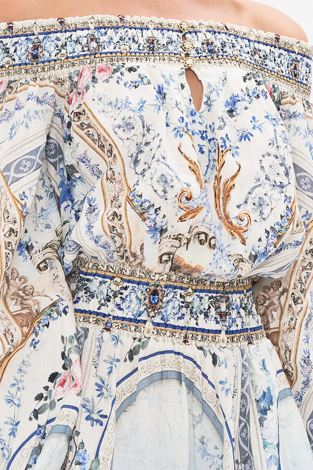 Detail view of model wearing CAMILLA designer off the shoulder mini dress in Season of the Siren print