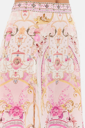 Detail view of model wearing CAMILLA pink maxi skirt in Fresco Fairytale print