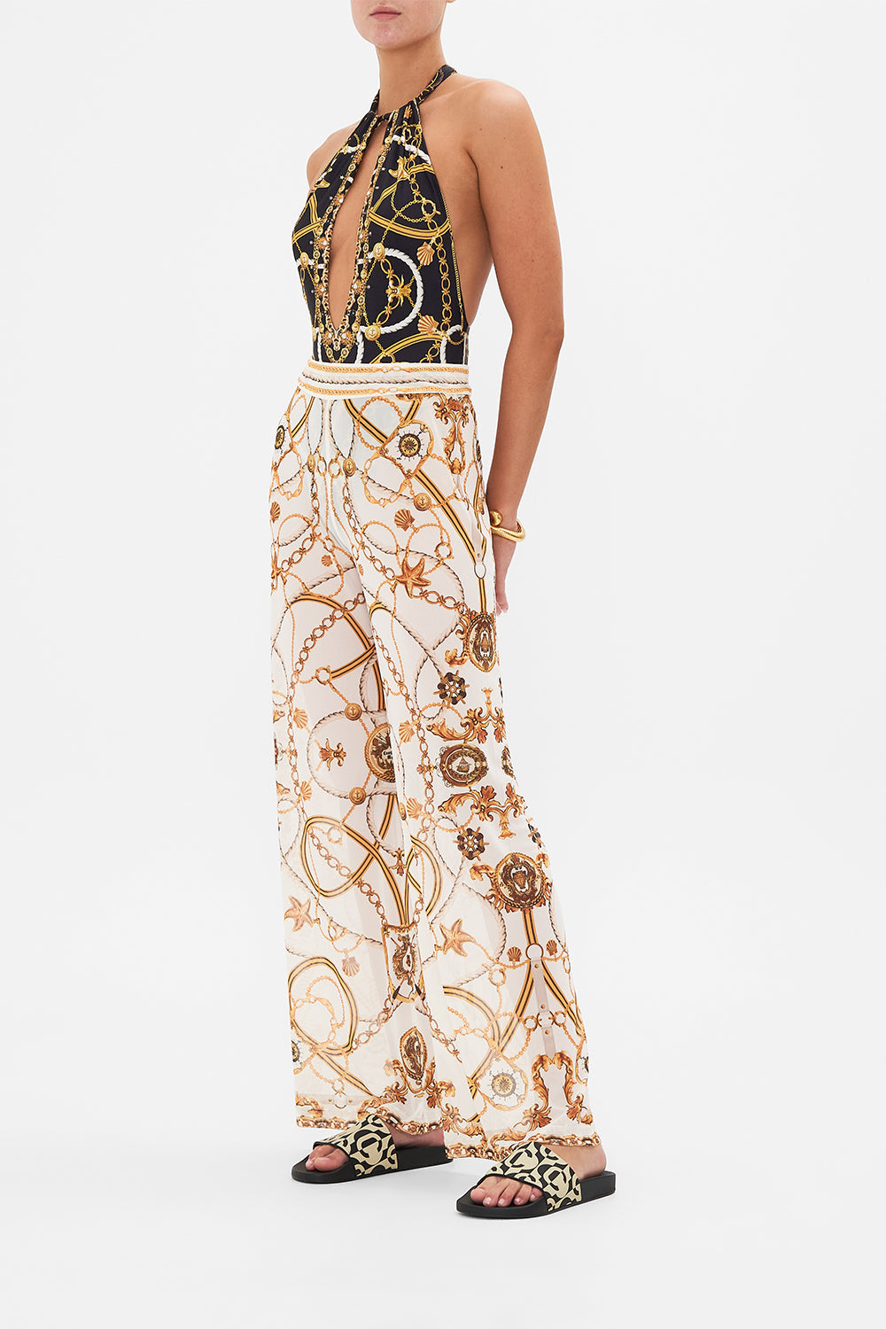 Side view of model wearing CAMILLA sheer mesh pants in Coast To Coast print 