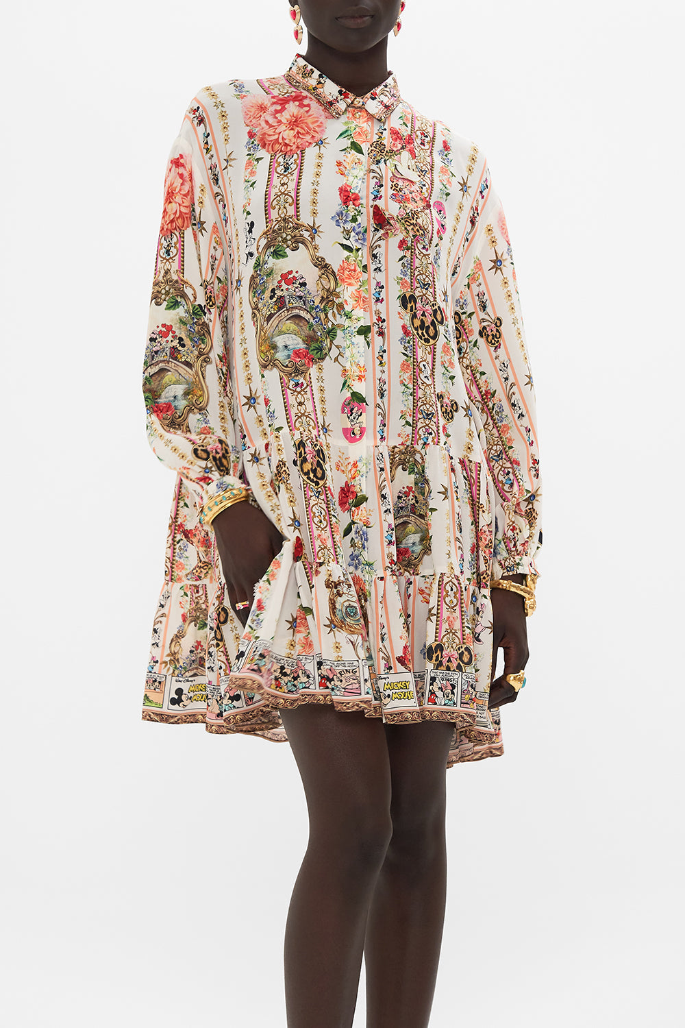 Crop view of model wearing Disney x CAMILLA silk shirt dress in Minnie Magic Forever print