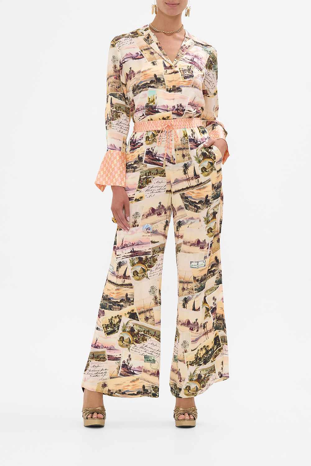The CAMILLA BABIES CROSS BACK JUMP DRESS WITH FRILL NECK NOTES FROM THE ROAD in our NOTES FROM THE ROAD print.