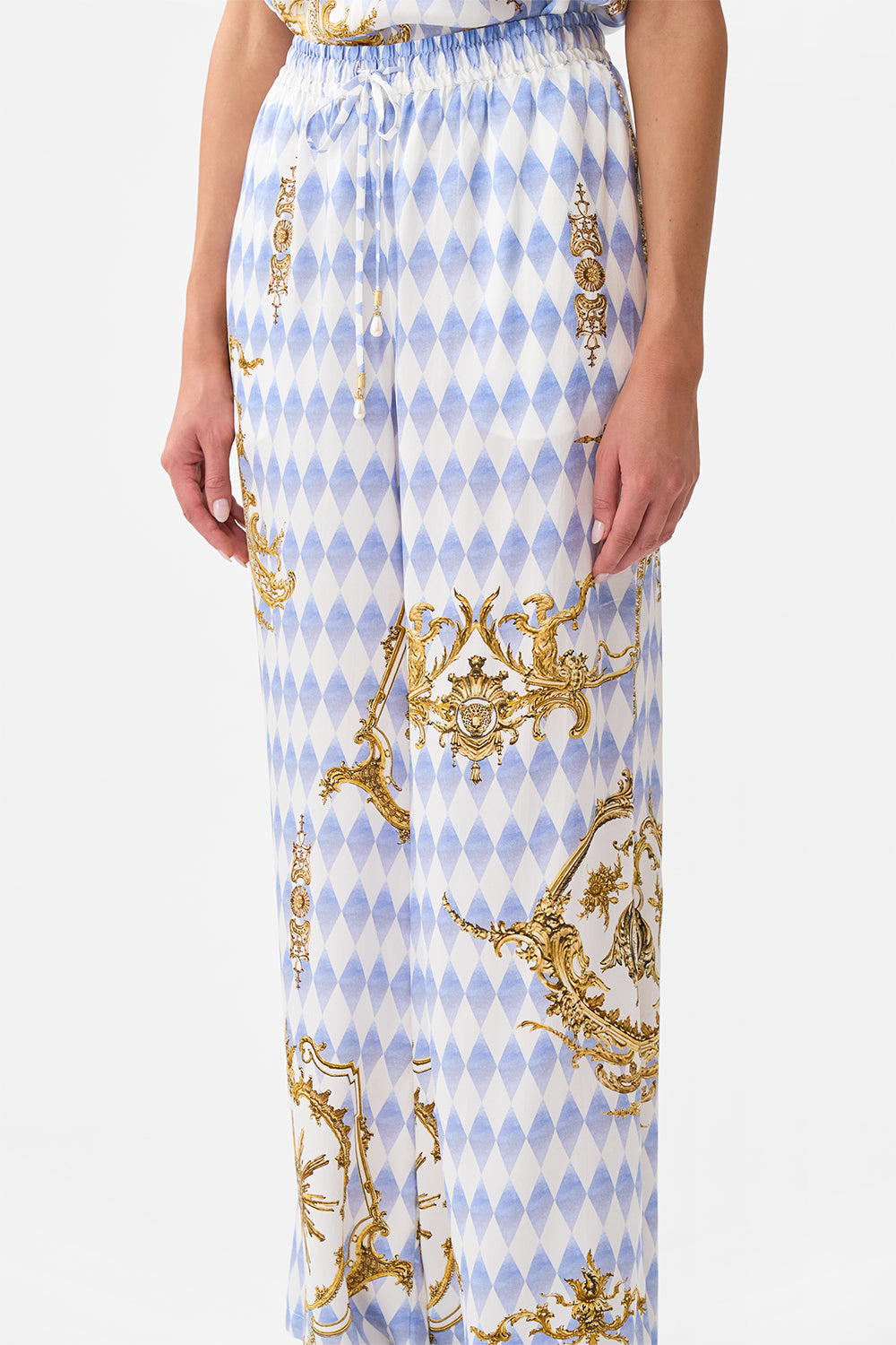 The CAMILLA STEPPED HEM SHIRT SONG OF SAINT ANTHONY in our  print.