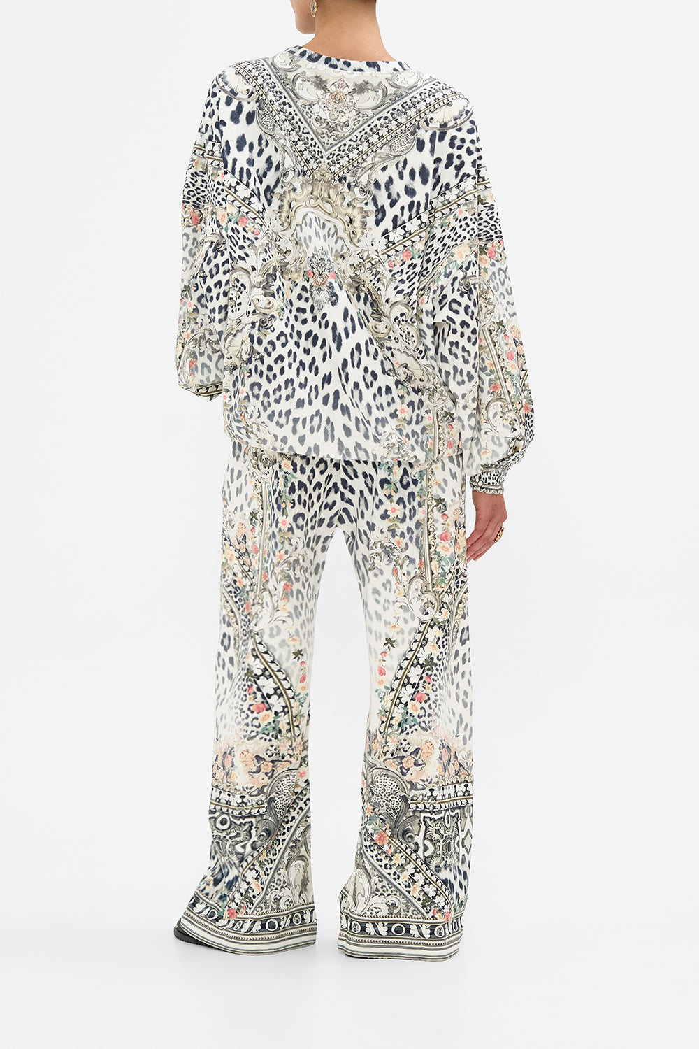 The CAMILLA MID LENGTH BOARDSHORT WITH ELASTIC WAIST NOTES FROM THE ROAD in our  print.