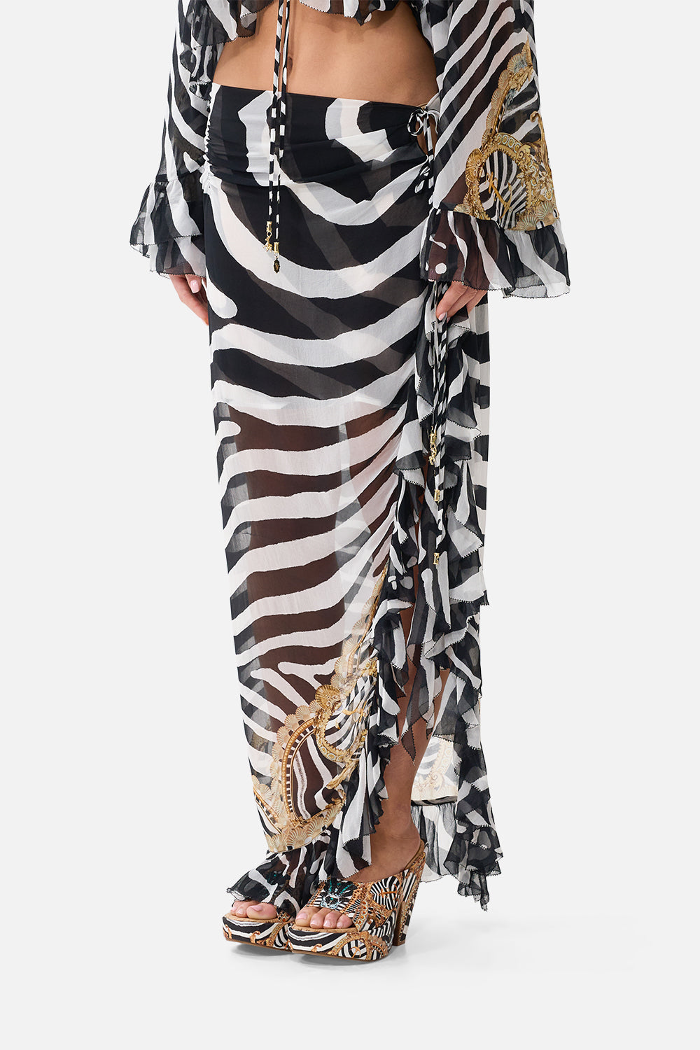 The CAMILLA Relaxed Wrap Tie Skirt With Ruffle in Print Zig Zag Zoo. Model View