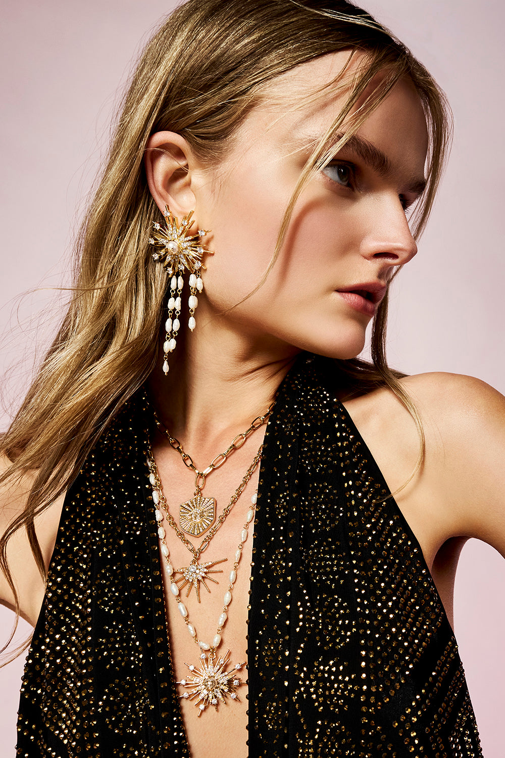 The CAMILLA Empress of Light Star Crystal Earrings in our Gold print, front view on model.